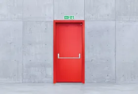 How should an emergency exit door be?