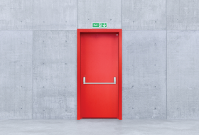How should an emergency exit door be?